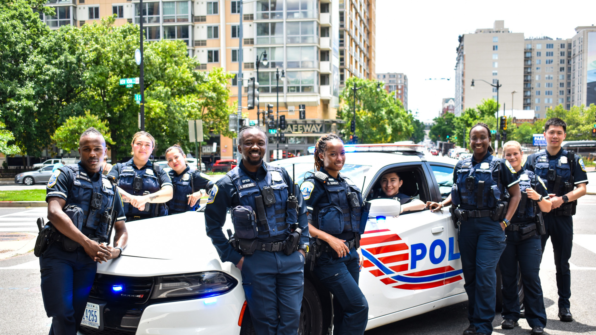 Police officers standing beside a patrol vehicle